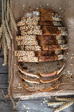 Slices of sourdough bread with wheat ears and grains