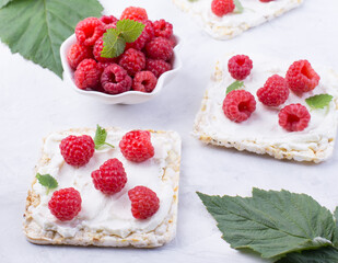 Toast with cream cheese and fresh raspberries. A delicious summer dish for breakfast.