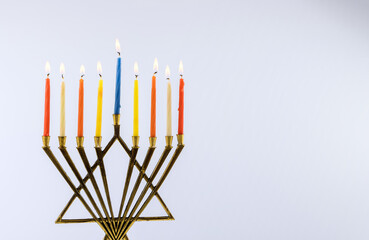 Jewish holiday Hanukkah with hanukkiah menorah on nine candles