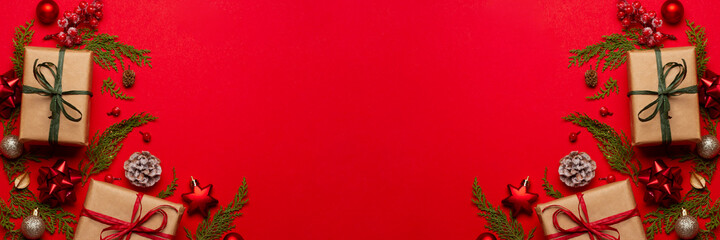 Christmas composition with decorations and ornametns on red background with empty space