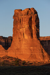 Large rock formation illuminated at sunset in Arches National Park, Utah