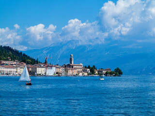 Naklejka premium Some sailboats sail in front of Salò-Garda lake-Italy