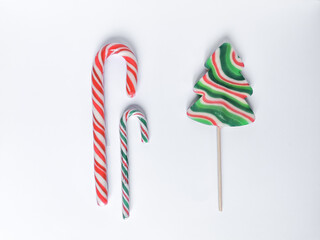 Kit of Christmas candies for sweet winter holidays. Red, green and white spiral stripes. Lollipop in Christmas tree form