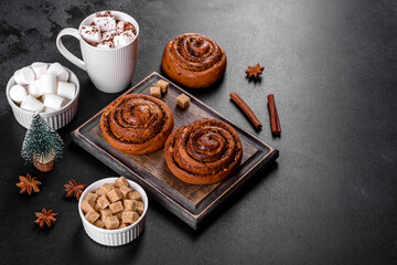 Freshly baked cinnamon roll with spices and cocoa filling on a black background