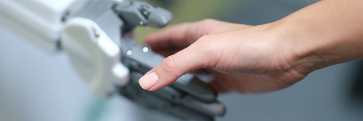 Closeup of handshake of female hand and artificial prosthesis