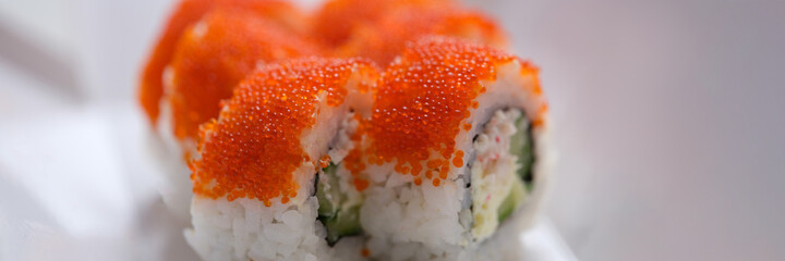 Closeup of portion of sushi with flying fish roe
