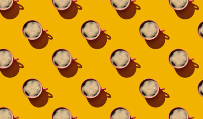Pattern of coffee mugs on yellow pastel background