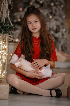 Cheerful cute little child girl with present