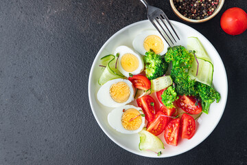 Fototapeta na wymiar salad vegetables and egg broccoli, tomato, cucumber, meal snack on the table copy space food background rustic. top view keto or paleo diet veggie vegetarian food