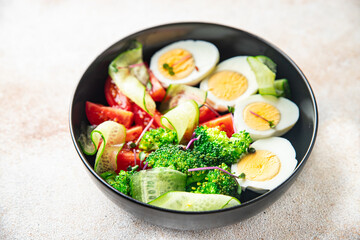 salad vegetables and egg broccoli, tomato, cucumber, meal snack on the table copy space food background rustic. top view keto or paleo diet veggie vegetarian food