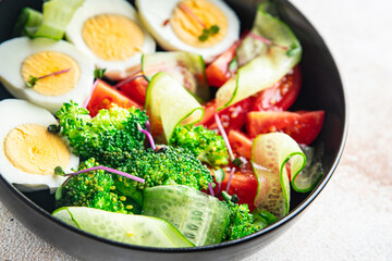 salad vegetables and egg broccoli, tomato, cucumber, meal snack on the table copy space food background rustic. top view keto or paleo diet veggie vegetarian food