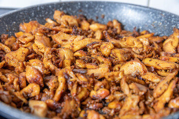 cooking chicken gyros in a pan