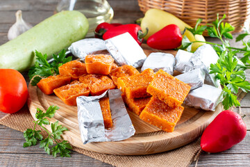 Frozen vegetable cubes on a cutting board. Life hacks, simple way to store vegetables