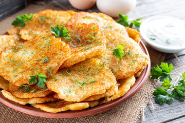 Potato pancakes or latkes on a wooden background