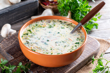 Cheese soup with mushrooms, potatoes and carrots. Delicious cozy first course, autumn food