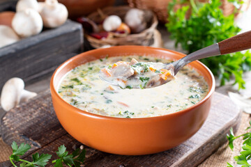 Cheese soup with mushrooms, potatoes and carrots. Delicious cozy first course, autumn food