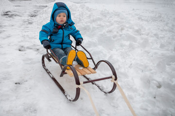 Fototapeta na wymiar Child on sledge