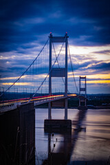Fototapeta na wymiar View Of Suspension Bridge Against Cloudy Sky