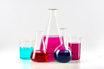 Laboratory flasks with colored liquid are in a row, isolated