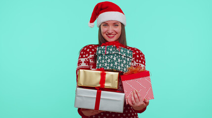 Girl in Christmas red sweater hat looking surprised at mount of boxes hands, excited by so many holiday gifts, lot of presents. Happy New Year presents shopping sale celebration merry holiday concept