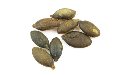 Few unshelled and roasted pumpkin seeds isolated on white background