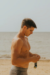 Hombre joven adolescente natacion. Deporte aire libre playa. Natacion naturaleza. Joven poniendose gafas de natacion. 