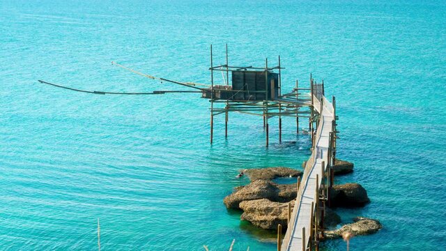 Trabocco of Punta Aderci at sunset, Vasto, Abruzzo. Trabucco a sort of Trebuchet, traditional wooden fishing house in southern Italy, on Costa dei Trabocchi (Coast Of the Trabocchi). RAW