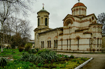 Fototapeta na wymiar a small Orthodox church with a green lawn near it