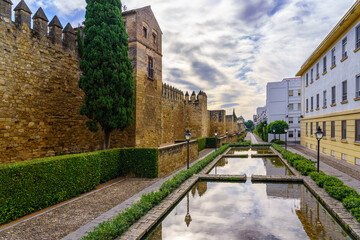Fototapeta na wymiar Outer wall of the Andalusian city of Cordoba with fountains and colored houses.