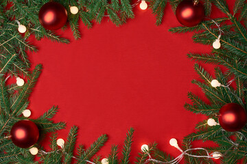 Fototapeta na wymiar frame of a Christmas wreath on a red background.
