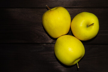 Green apples on a dark wooden background with copy space