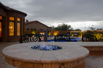 A Desert landscaped backyard in Arizona consisting of and outdoor BBQ, pool, spa and outdoor fireplace.