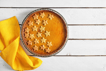 fresh homemade pumpkin pie on white wooden table. top view