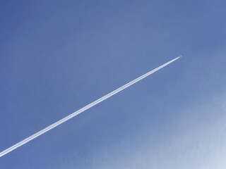 Jet leaving vapor trail contrail across sky
