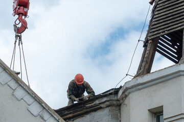 Repair of the roof of a beautiful old building in the city center. High-altitude work. Workers...