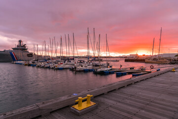 Dramatic colourful sky over a harbour at sunset. Reykjavik, Iceland.