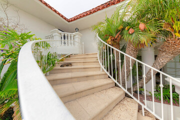 Concrete stairs outside a residential house with sleeping cat at the step in Oceanside, California