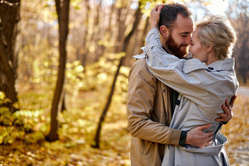 Happy caucasian lovers hugging at park. Cute beautiful couple in love embracing during date. Lifestyle, people concept. adorable man and woman hugging each other, tenderness between two people