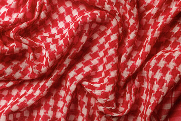 Draped shemagh of red white colors background. Arab desert scarf hirbawi texture. Folded cotton...