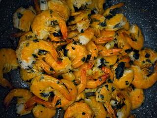 Fried prawns. Roasted shrimps in skillet baked with lemon, garlic, butter and parsley