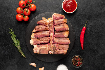 grilled t-bone steak with spices on a stone background