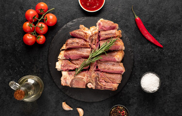grilled t-bone steak with spices on a stone background