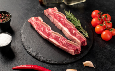 raw marbled beef ribs on stone background