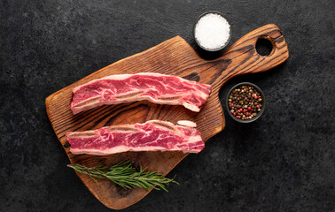 Fototapeta na wymiar raw marbled beef ribs on stone background
