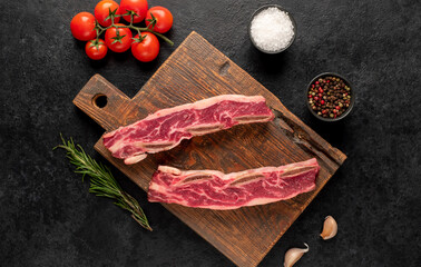 raw marbled beef ribs on stone background