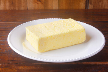fresh organic farm yellow butter made with cow's milk on rustic wooden table