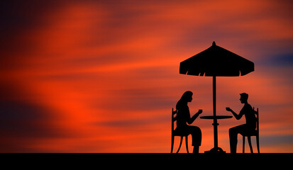 Silhouette of a couple having a cafe and dating  at sunset