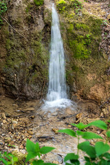 Obraz premium A spectacular waterfall running wild and free as one of the most beautiful sights in nature. Natural phenomenon which takes your breath away. Waterfall in Serbia. Mountain river waterfall. 