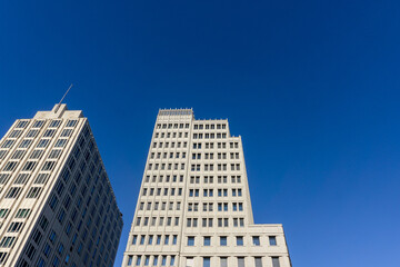 Looking up at the clear sky and buildings.