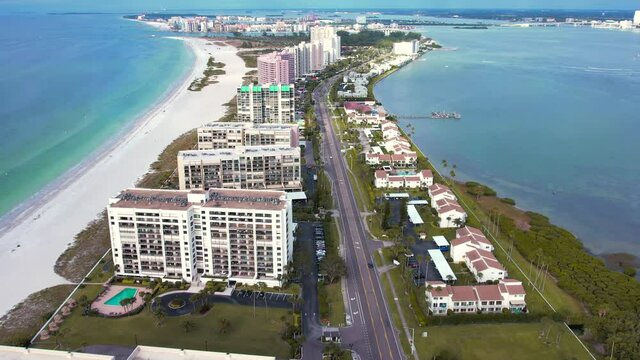 Panorama of City Clearwater Beach FL. Summer vacations in Florida. Beautiful View on Hotels and Resorts on Island. Blue color of Ocean water. American Coast or shore Gulf of Mexico. Aerial videography